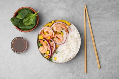 Photo of Delicious poke bowl with shrimps, rice and vegetables served on light grey table, flat lay