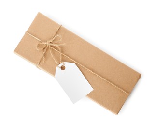 Gift box wrapped in kraft paper with bow and tag isolated on white