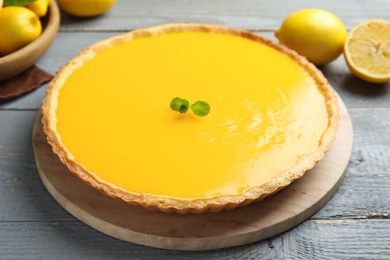 Delicious homemade lemon pie with mint on wooden table