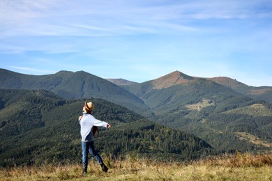 Young woman in beautiful mountains on sunny day