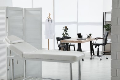 Modern medical office interior with couch. Doctor's workplace