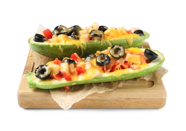 Wooden board with baked stuffed zucchinis on white background