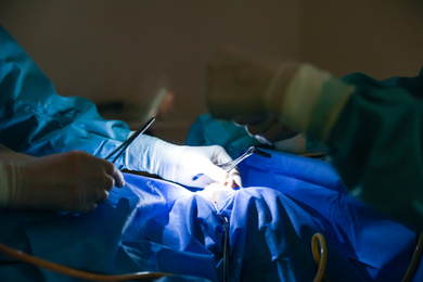 Professional doctors performing operation in surgery room, closeup