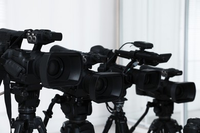 Modern video cameras indoors. Professional media equipment for broadcasting event