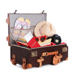 Open vintage suitcase with clothes packed for summer vacation isolated on white