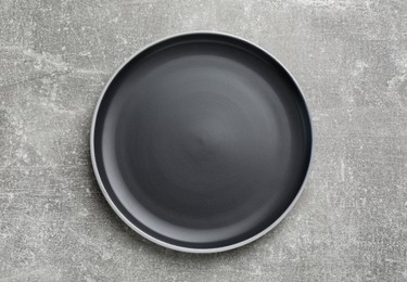 New dark plate on light grey table, top view