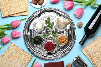 Flat lay composition with symbolic Passover (Pesach) items and meal on color background