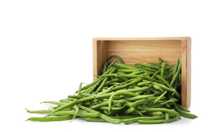Fresh green beans and wooden crate on white background