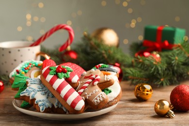 Delicious Christmas cookies on wooden table against blurred lights