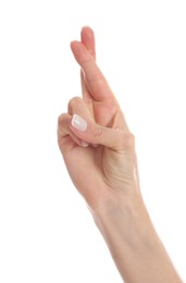 Woman with crossed fingers on white background, closeup. Superstition concept