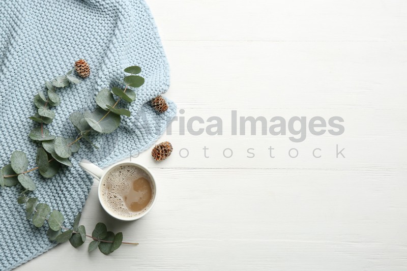 Photo of Flat lay composition with coffee and warm plaid on white wooden table, space for text