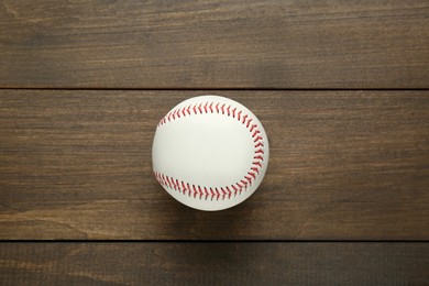 Photo of Baseball ball on wooden table, top view