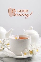 Aromatic jasmine tea and fresh flowers on white marble table. Good morning