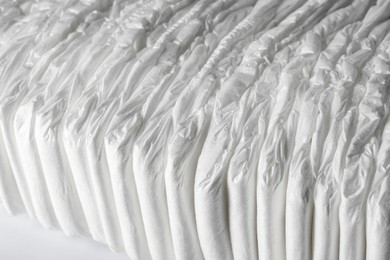 Photo of Many disposable diapers on white background, closeup view