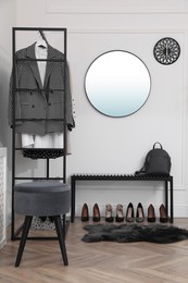 Dressing room with stylish clothes and shoes. Elegant interior design