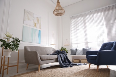 Beautiful living room interior with comfortable gray sofa