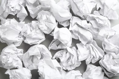 Photo of Crumpled sheets of paper on light background, closeup