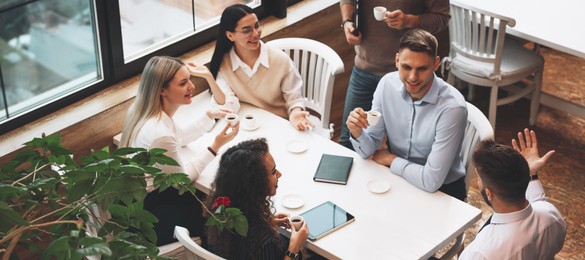 Image of Group of coworkers having coffee break in cafe. Banner design