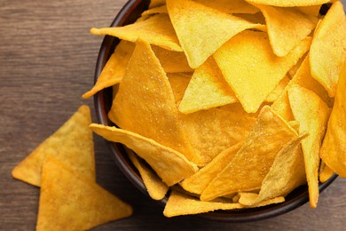 Photo of Tortilla chips (nachos) on wooden table, flat lay