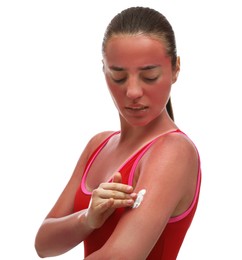Woman applying cream on sunburn against white background