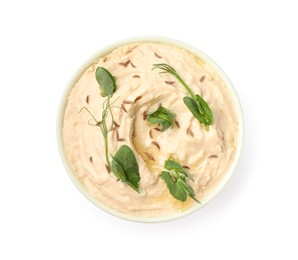 Photo of Bowl of tasty hummus with pea leaves isolated on white, top view