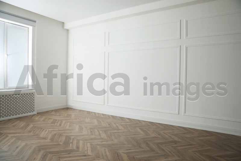 Photo of Parquet floor in light spacious empty room