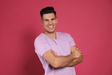 Handsome man laughing on pink background. Funny joke