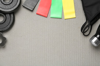 Photo of Flat lay composition with fitness elastic bands on grey background. Space for text