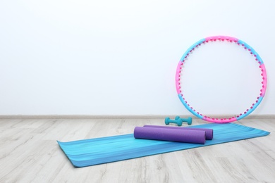 Hula hoop, yoga mats and dumbbells in physiotherapy gym