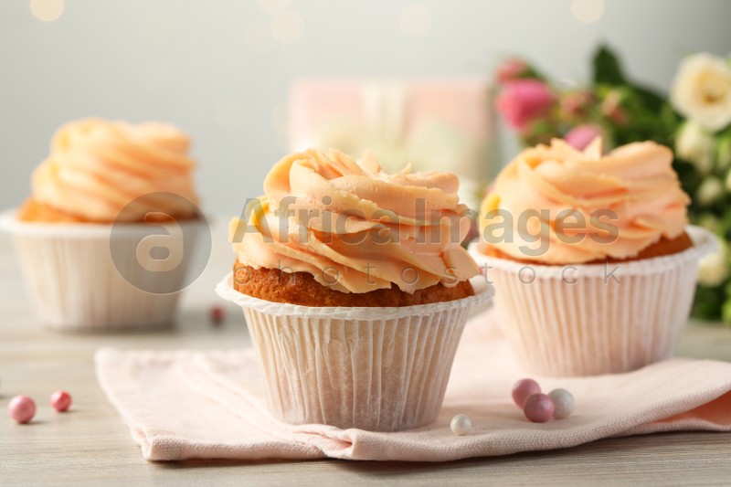 Photo of Tasty cupcakes with cream on table, closeup