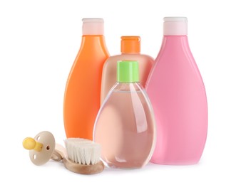Bottle of baby oil, other cosmetic products and accessories on white background