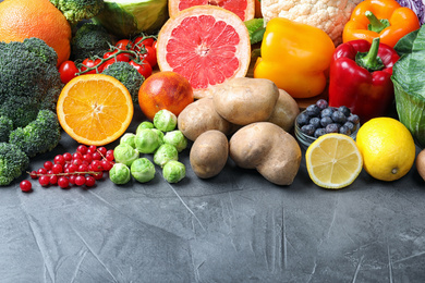 Different products rich in vitamin C on grey table