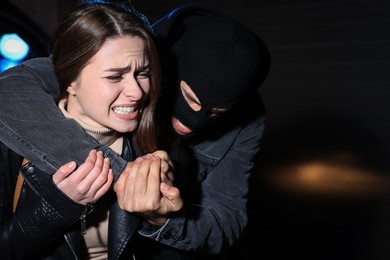 Photo of Woman defending herself from attacker outdoors at night