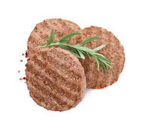 Tasty grilled hamburger patties with seasonings on white background