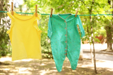 Laundry line with child's clothes outdoors on sunny day