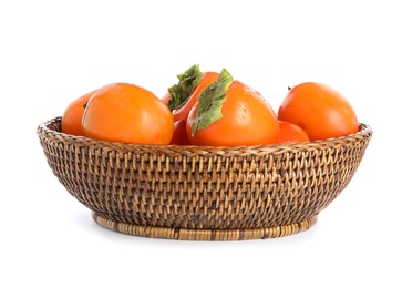 Wicker bowl with delicious persimmons isolated on white