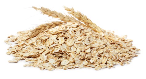 Photo of Pile of raw oatmeal and spikelets on white background