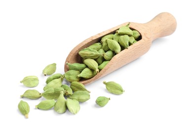 Wooden scoop with dry cardamom seeds on white background