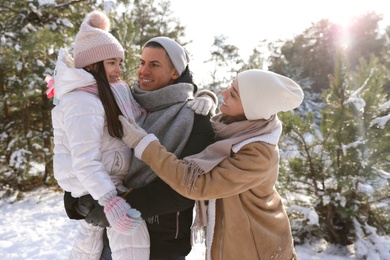 Happy family outdoors on winter day. Christmas vacation