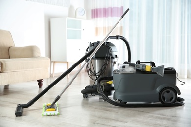 Professional cleaning equipment on floor indoors, space for text