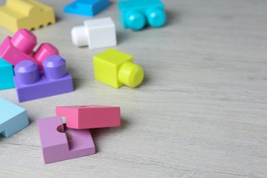 Colorful wooden blocks on white table, space for text. ABA therapy concept