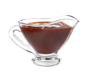 Glass gravy boat with barbecue sauce on white background
