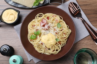 Delicious spaghetti with cheese sauce and meat served on wooden table, flat lay