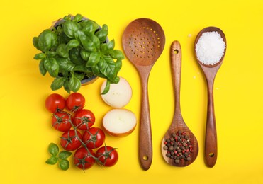 Flat lay composition with cooking utensils and fresh ingredients on yellow background