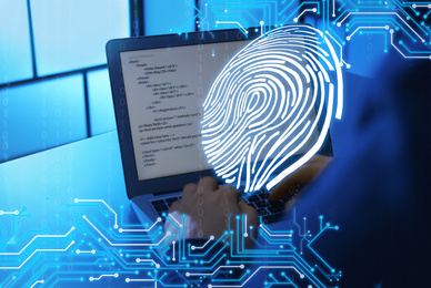 Fingerprint identification. Man working with laptop at table, closeup