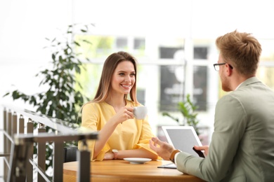 Insurance agent consulting young woman in office