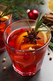 Photo of Glass with delicious punch drink on grey table, closeup