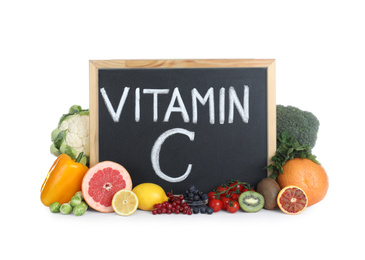 Chalkboard with phrase VITAMIN C and fresh products on white background