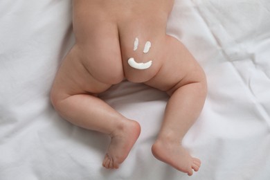 Cute little baby with cream on body, top view