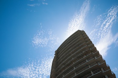 Photo of Unfinished building against blue sky, low angle view. Space for text
